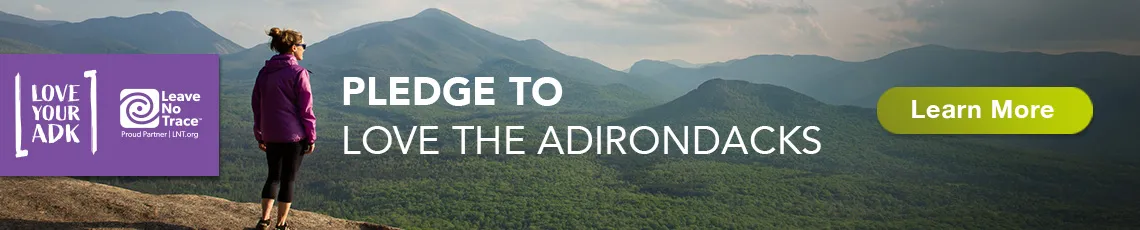The Love Your ADK pledge banner with a hiker in the foreground and mountains in the background