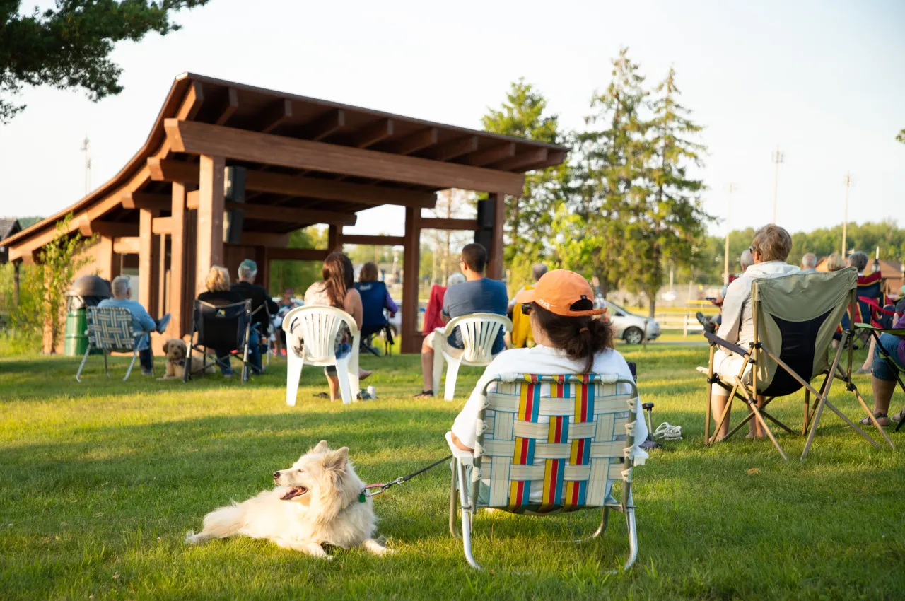 A group watching a live performance at the Sunset Stage.