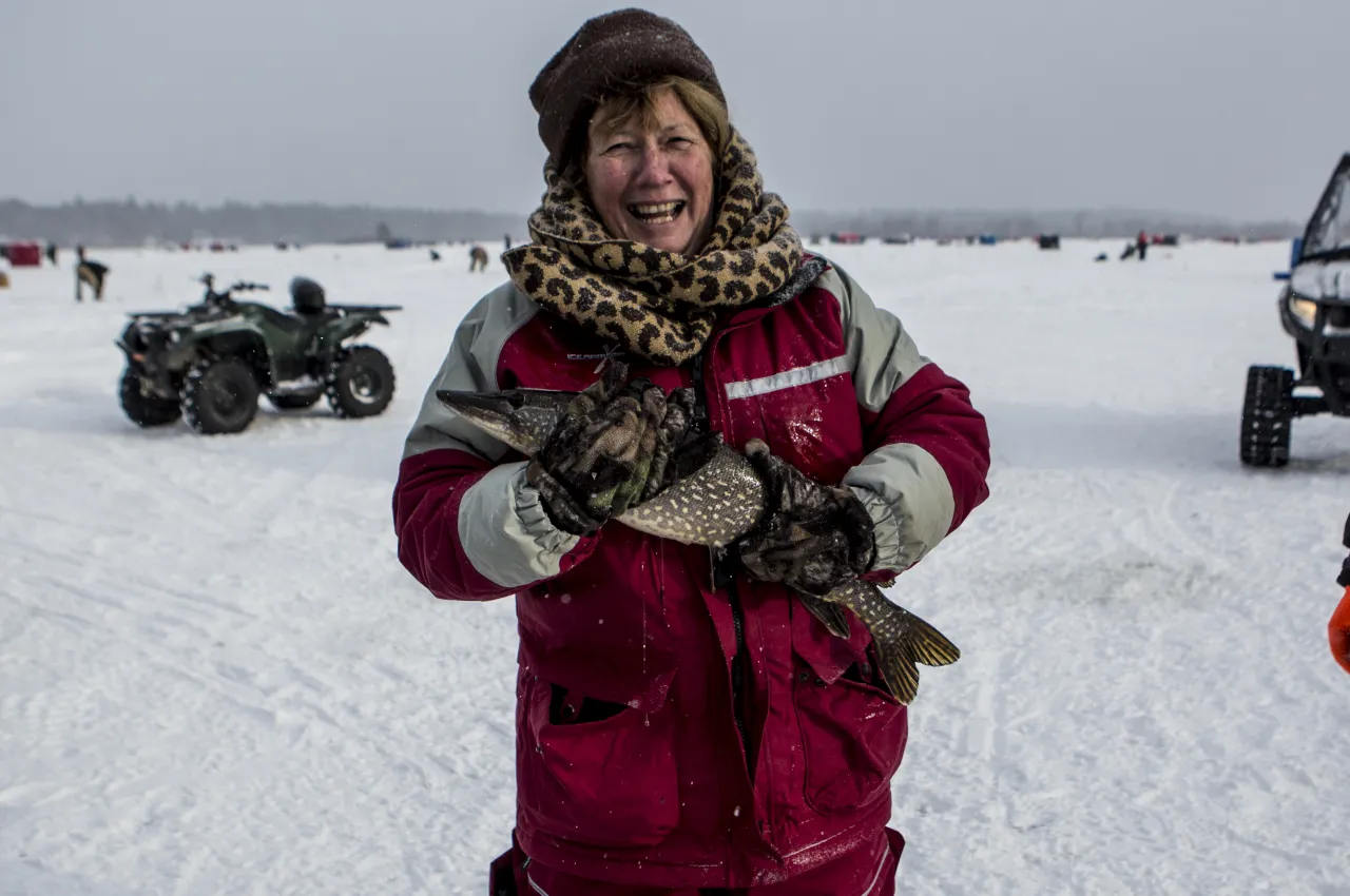 A woman holds a fish at The Northern Challenge.