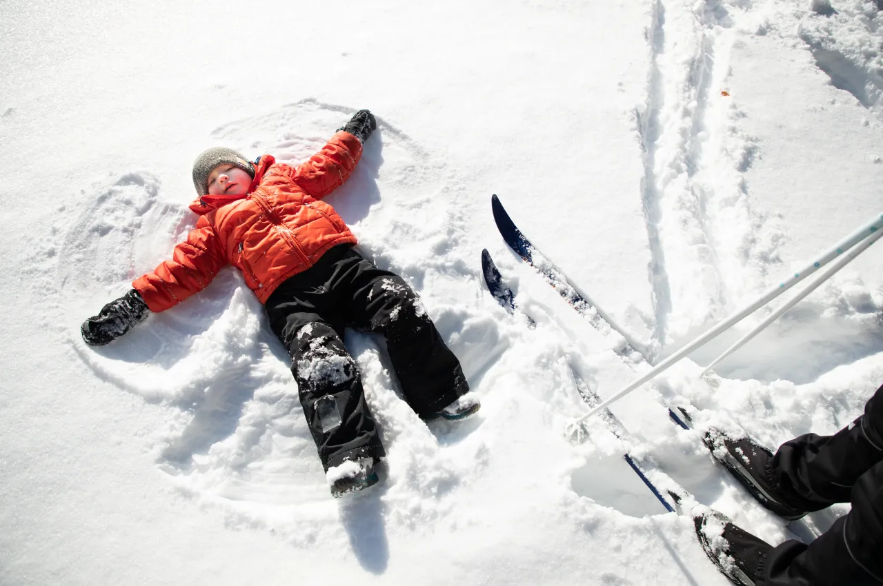 A child making a snow angel.