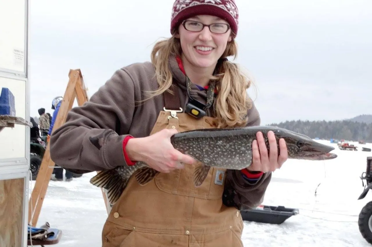 A woman holds a fish at The Northern Challenge.