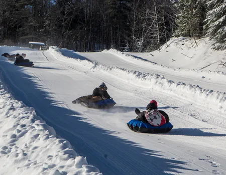 A few people tubing down the Mt Pisgah tubing runs