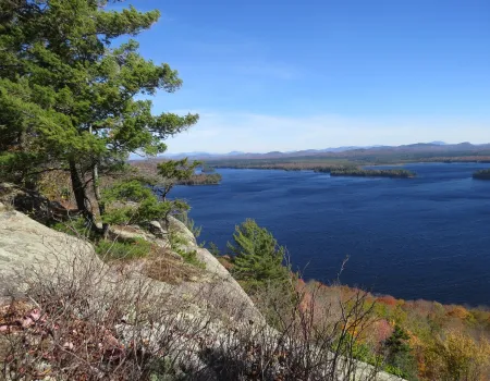 A summer view of Lake Lila from a rocky outcrop with pines.