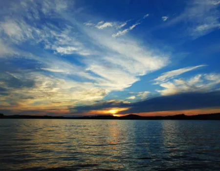 A sunset over a large lake