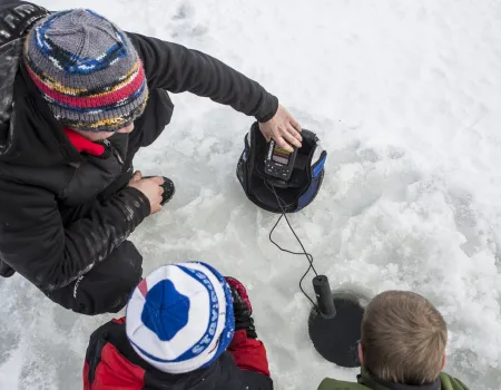 A family ice fishes