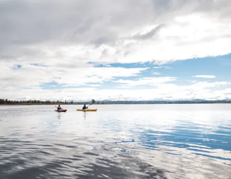 Two paddlers on a large pond