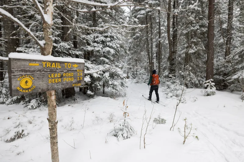 A skier passes a junction.