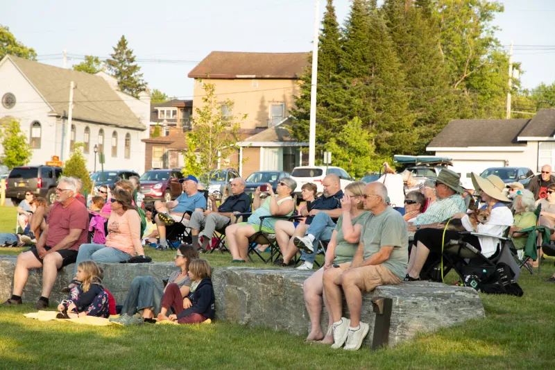 A large crowd listening to live music outside