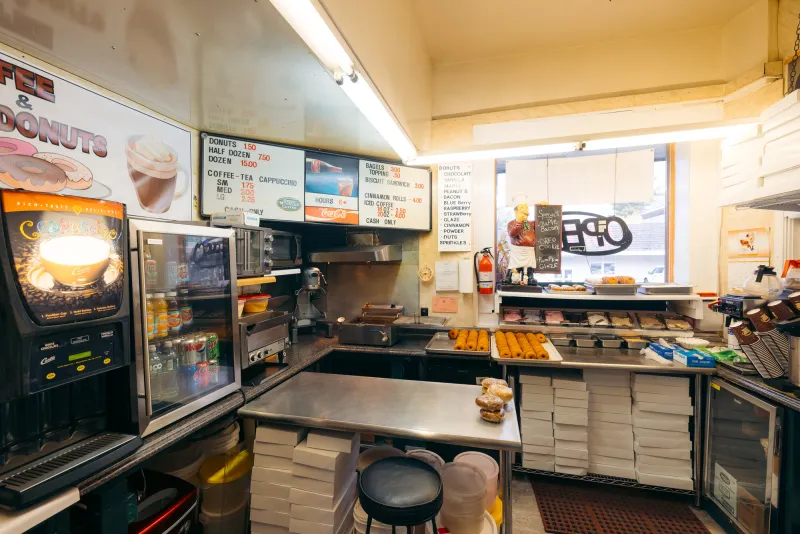 Inside a small, tidy donut shop kitchen.