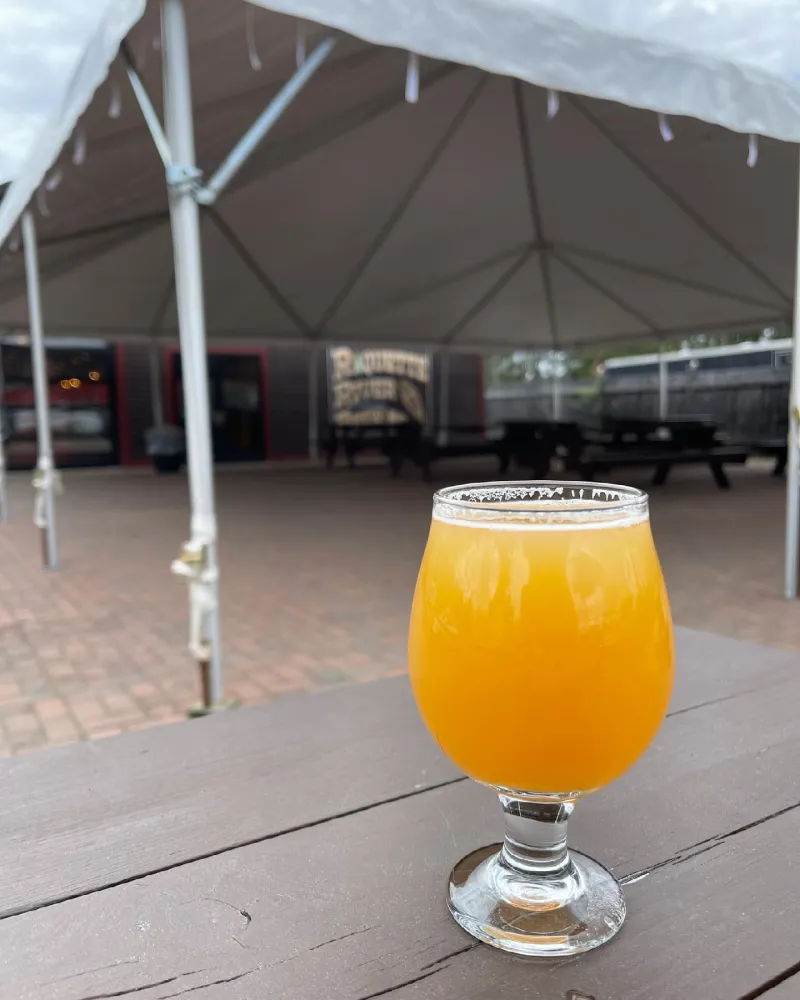 A refreshing beer posed on the patio at Raquette River Brewing