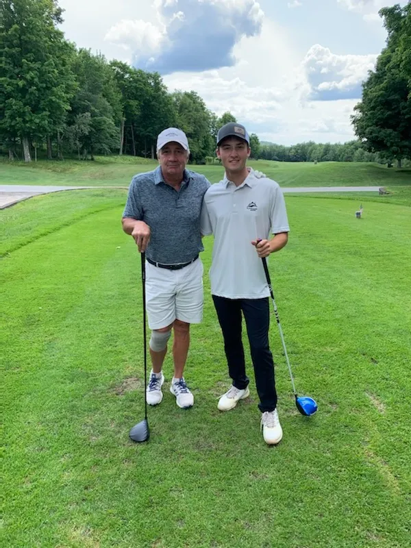 Nick and his grandfather pose on the #1 tee.