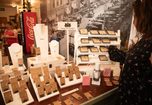 A woman looks at jewelry.