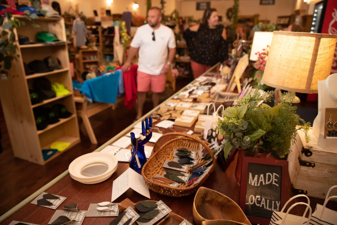 A table in a gift shop shows fashionable earrings, other small gift items with an Adirondack/natural theme.