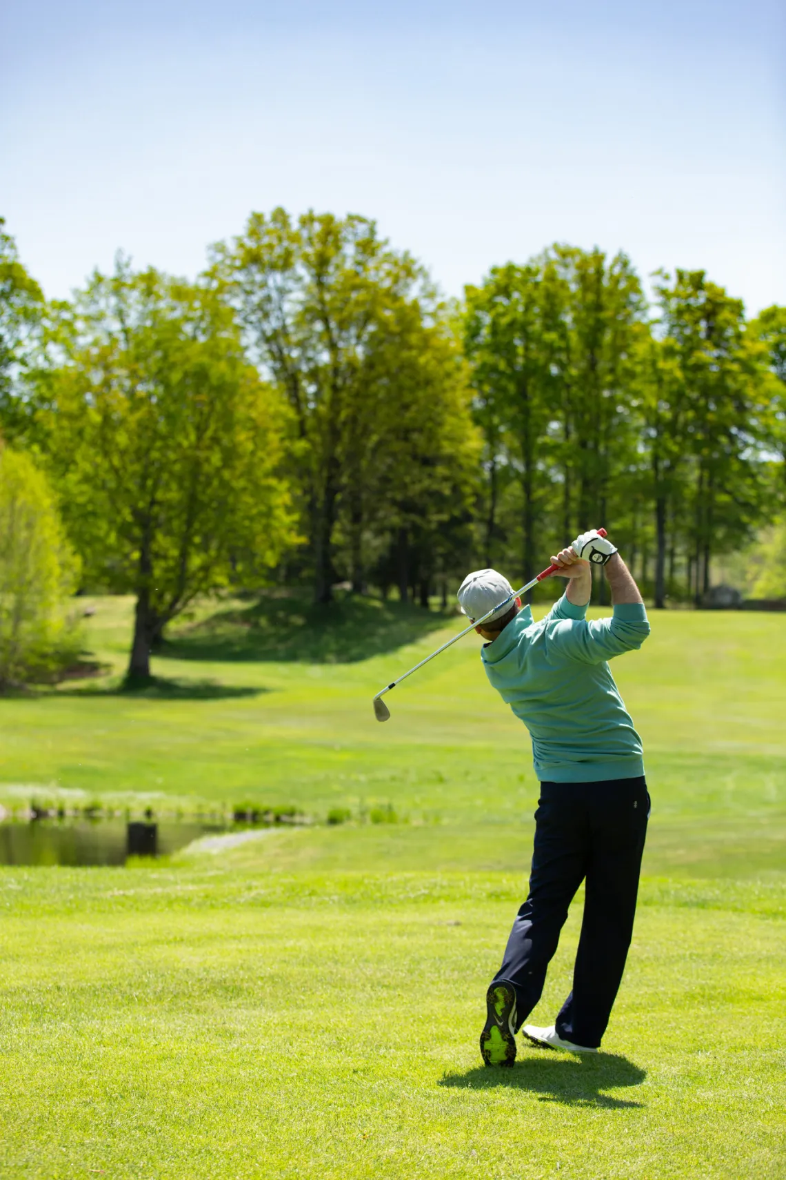 A man at the end of his golf swing