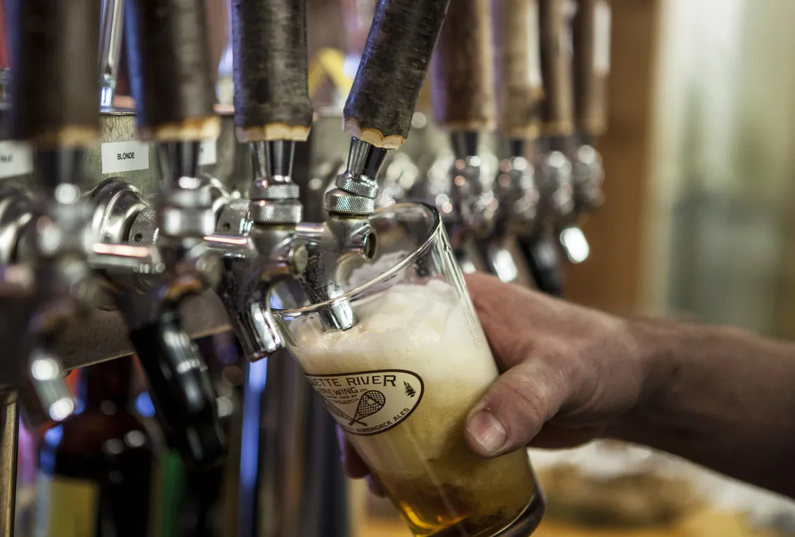 Close up shot of a draught beer being poured at Raquette River Brewing