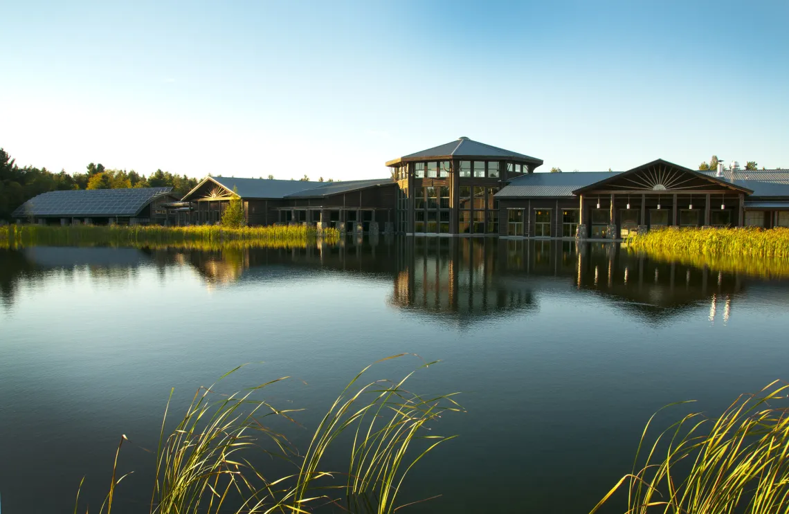 The wild center entrance featuring a beautiful lake outside the building.