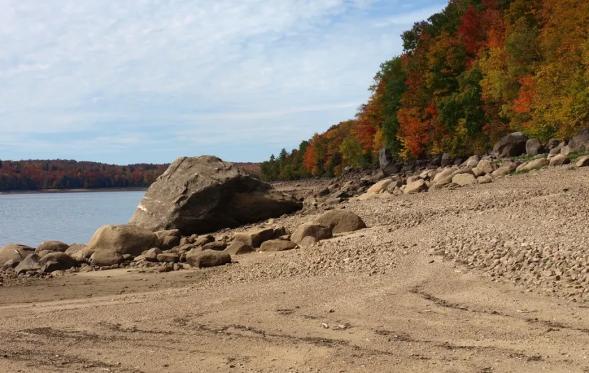 The sandy shores of Carry Falls makes a nice contrast with fall foliage.