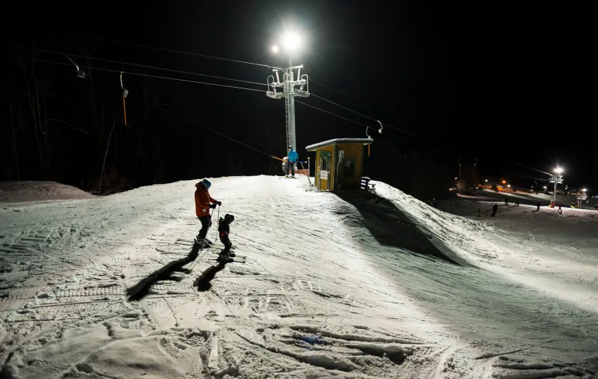 Skiers about to do a night run on Mt Pisgah