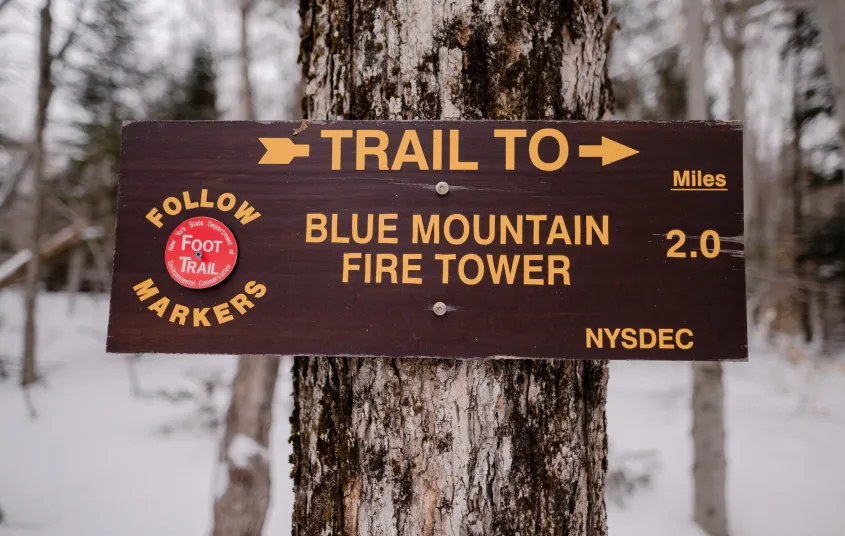 A wooden sign for Blue Mountain Fire Tower