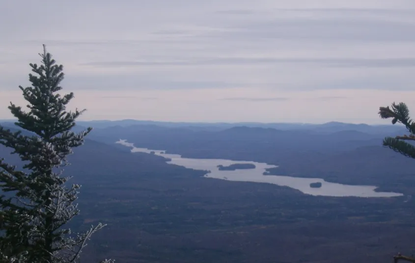 A long lake seen from the top of a mountain