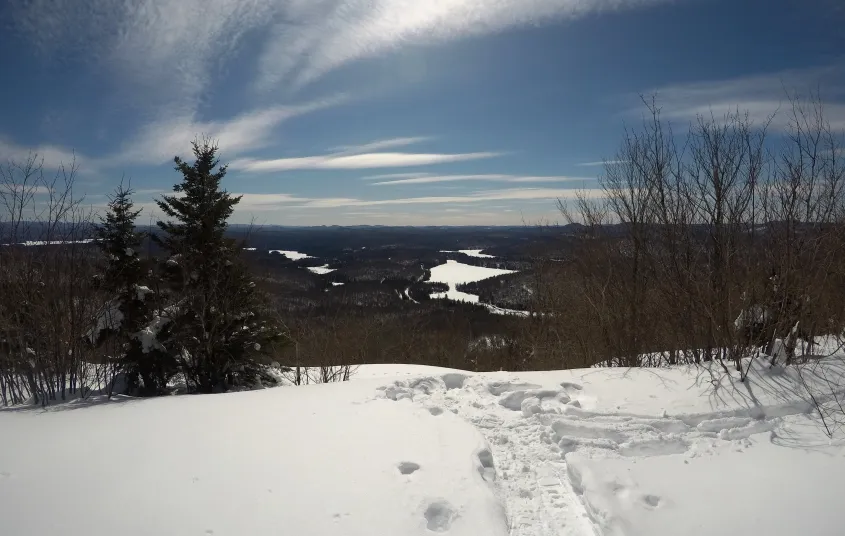 The view of a few lakes from a clearing atop a mountain