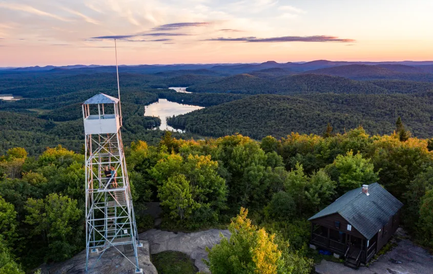 A firetower with the setting sun as a backdrop