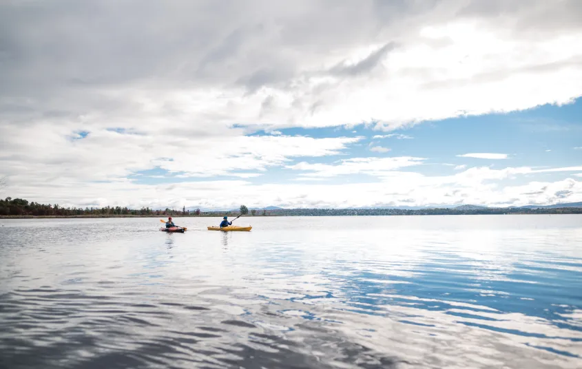 Two paddlers on a large pond