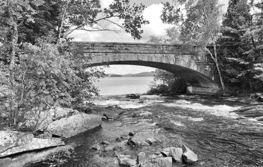 A historic photo of a bridge and falls