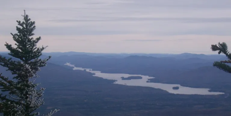 A long lake seen from the top of a mountain