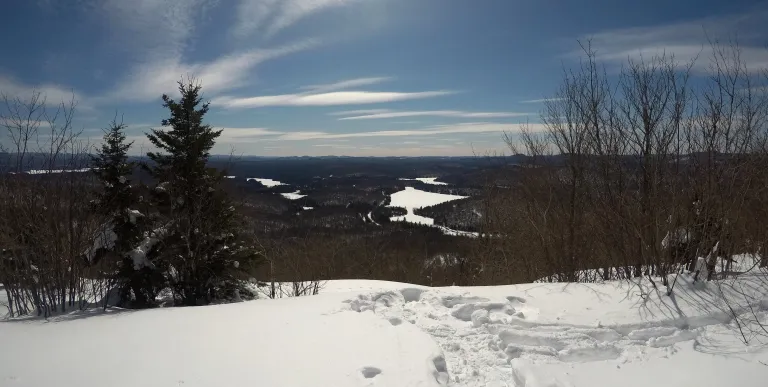 The view of a few lakes from a clearing atop a mountain