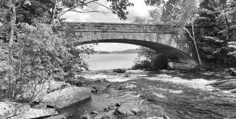 A historic photo of a bridge and falls
