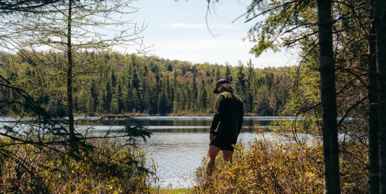 A hiker by a small pond