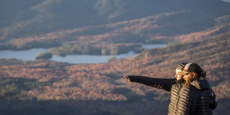 People pointing at things from top of mountain